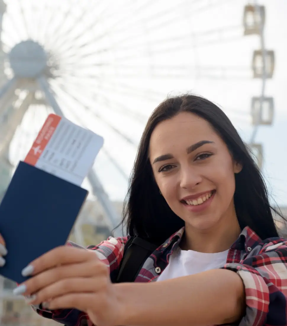 portrait-smiling-woman-showing-air-ticket-passport